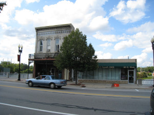 Two stores remain where once a row of stores extended from the east to the west banks of the Flat River. Fire destroyed several stress on the right, and emotion took buildings on the left. A few stories remain on pilings. Photo by Joel Thurtell 9-5-2008.